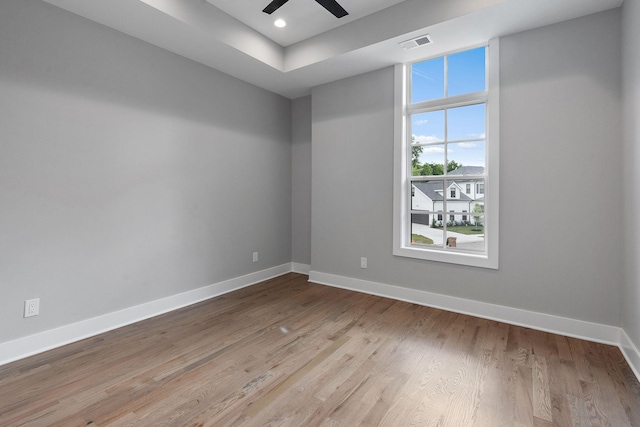 spare room featuring ceiling fan and light hardwood / wood-style flooring