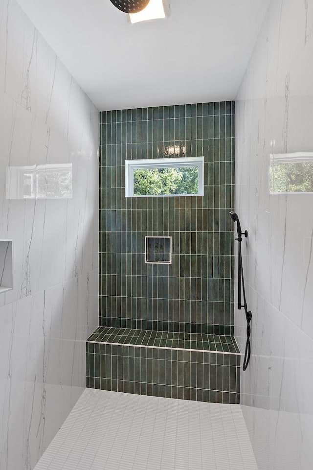 bathroom with a tile shower