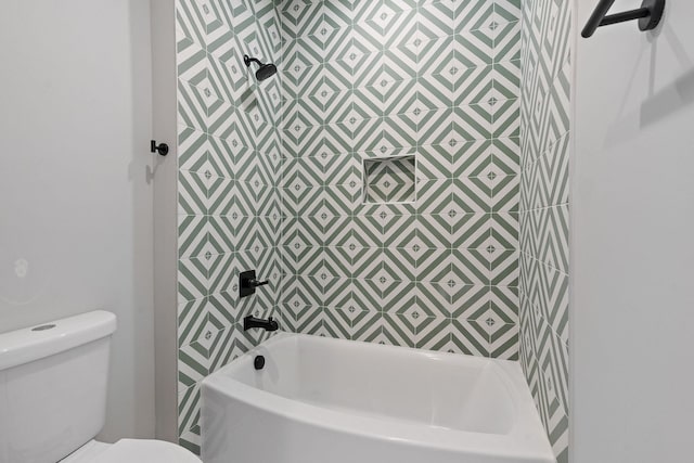 bathroom featuring shower / washtub combination and toilet