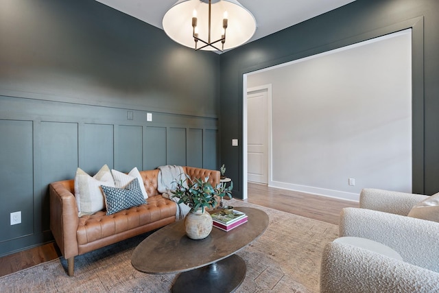 living room with a chandelier and wood-type flooring