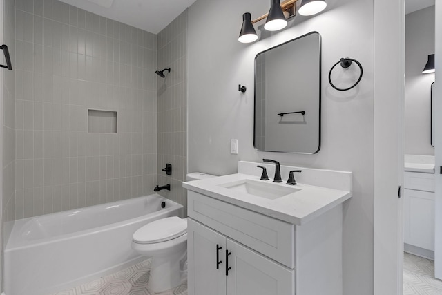 full bathroom with toilet, tiled shower / bath, and vanity