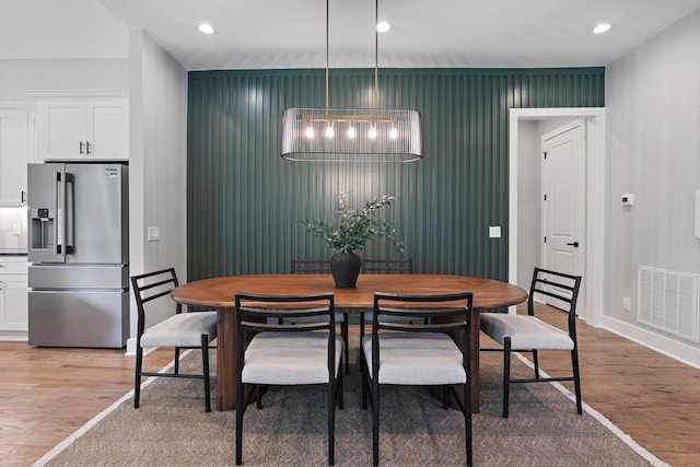 dining space featuring wood-type flooring