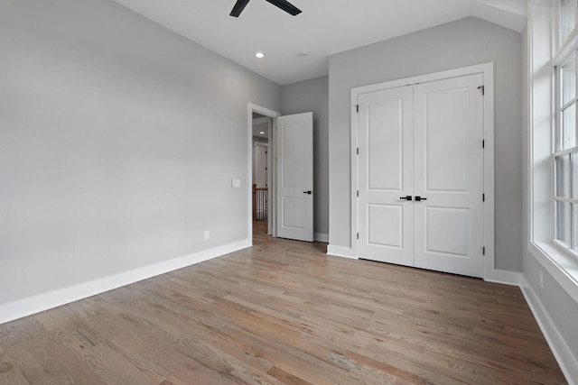 unfurnished bedroom featuring light hardwood / wood-style flooring, a closet, and ceiling fan