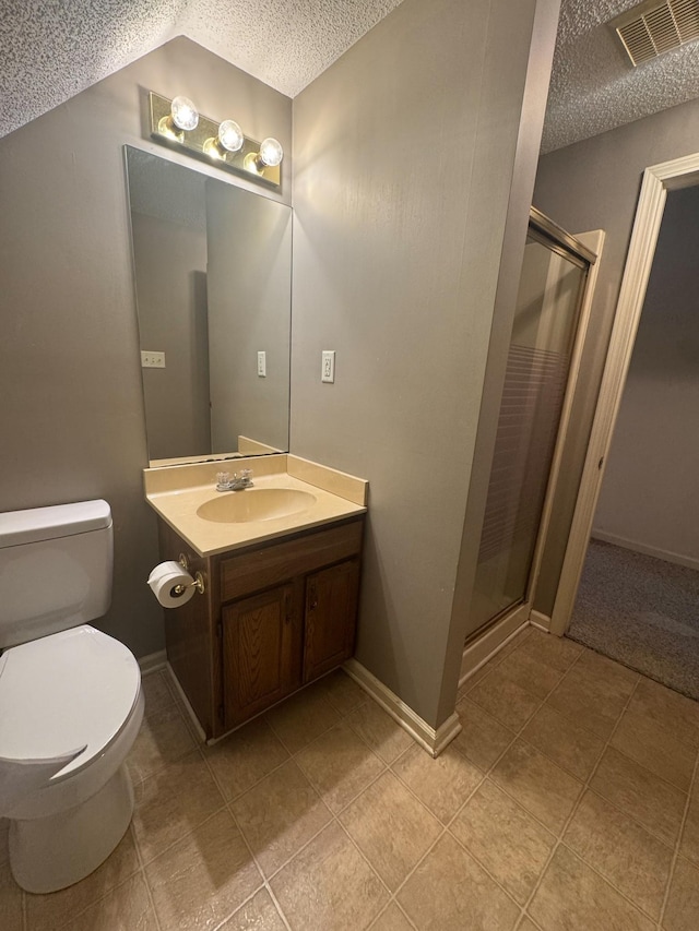 bathroom featuring visible vents, vanity, a textured ceiling, and a shower stall