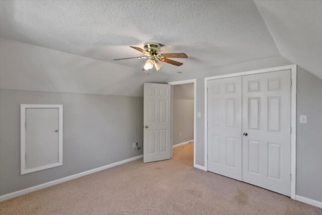 additional living space featuring baseboards, a ceiling fan, carpet flooring, and vaulted ceiling