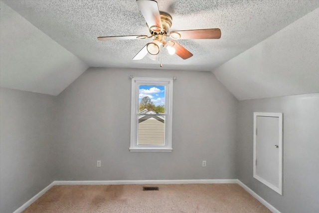 bonus room with carpet flooring, visible vents, and lofted ceiling