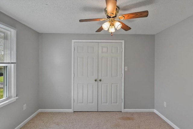 unfurnished bedroom featuring a closet, baseboards, and carpet floors
