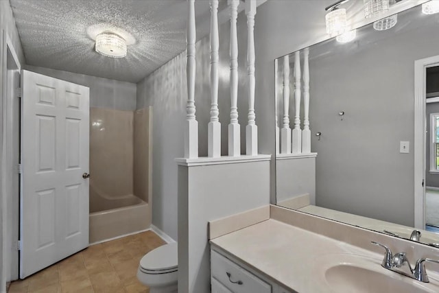 full bath featuring toilet, tile patterned floors, vanity, and a textured ceiling