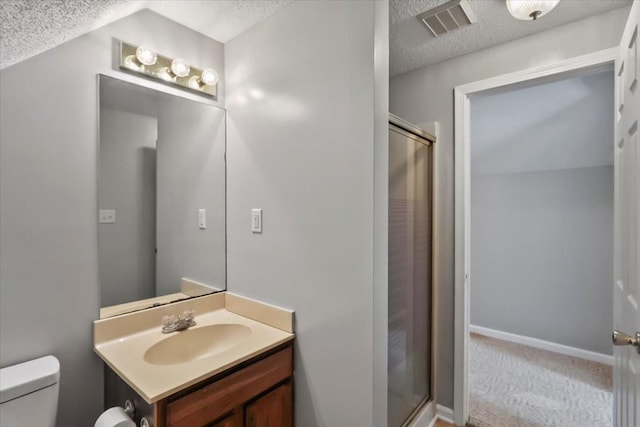 full bath with a shower stall, a textured ceiling, visible vents, and toilet