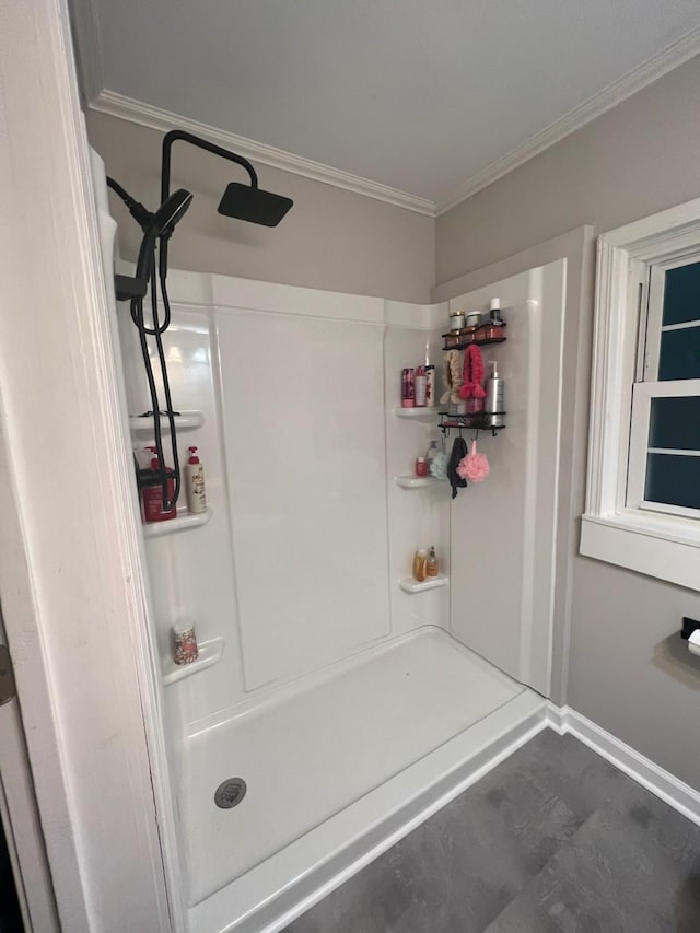 bathroom with walk in shower and ornamental molding