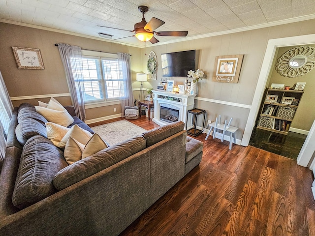 living room featuring crown molding, dark hardwood / wood-style floors, and ceiling fan