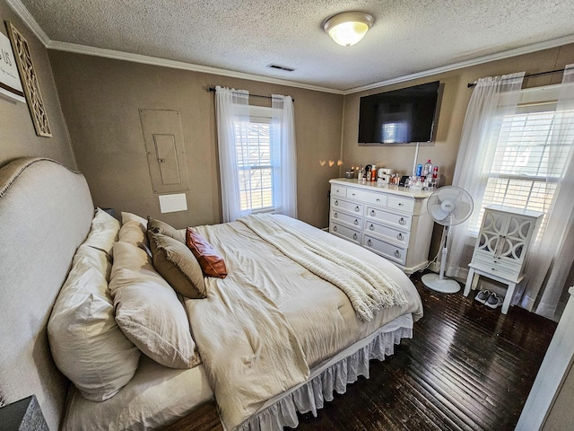 bedroom featuring crown molding, dark wood-type flooring, and a textured ceiling