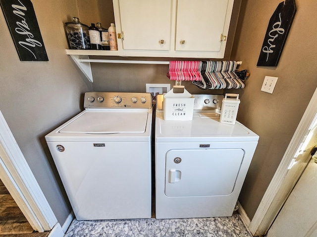 laundry room with cabinets and washing machine and clothes dryer