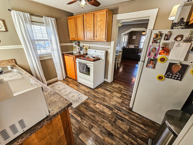 kitchen featuring white appliances, a textured ceiling, dark hardwood / wood-style floors, and ceiling fan