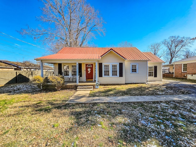 view of front of home featuring covered porch and a front yard