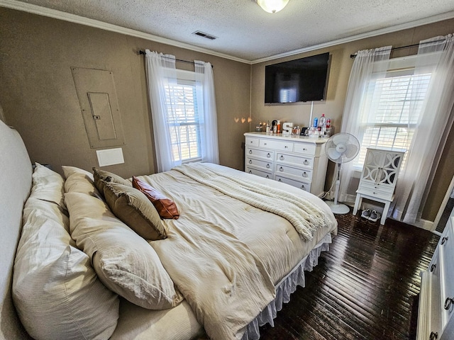 bedroom featuring dark wood-type flooring, a textured ceiling, and crown molding