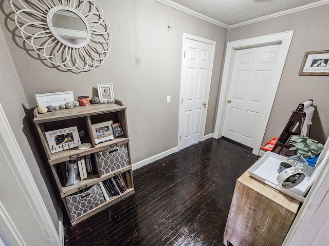 entryway with ornamental molding, dark hardwood / wood-style floors, and a textured ceiling