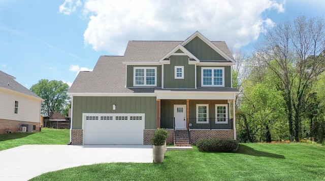 craftsman-style house featuring a garage, covered porch, and a front yard