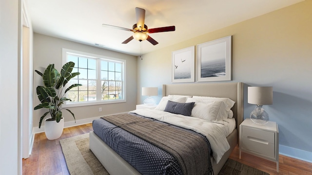 bedroom featuring hardwood / wood-style floors and ceiling fan