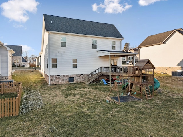 rear view of property featuring central AC, a playground, and a lawn