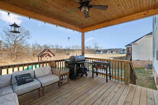 wooden terrace with ceiling fan, a grill, and an outdoor hangout area