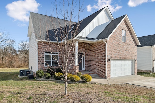 view of front facade with central AC unit, a garage, and a front yard