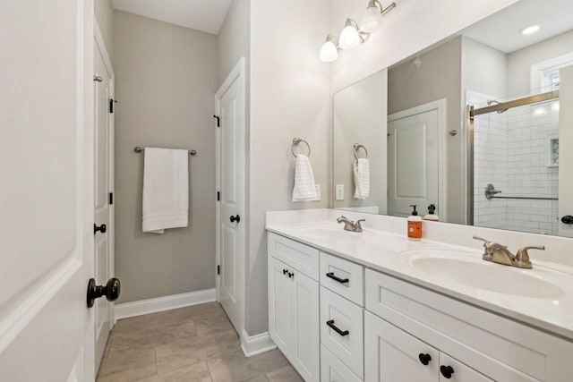 bathroom featuring vanity, an enclosed shower, and tile patterned flooring