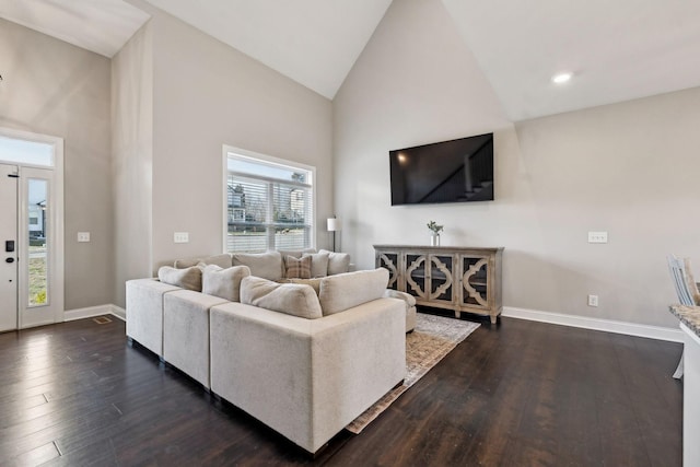 living room with high vaulted ceiling and dark hardwood / wood-style floors