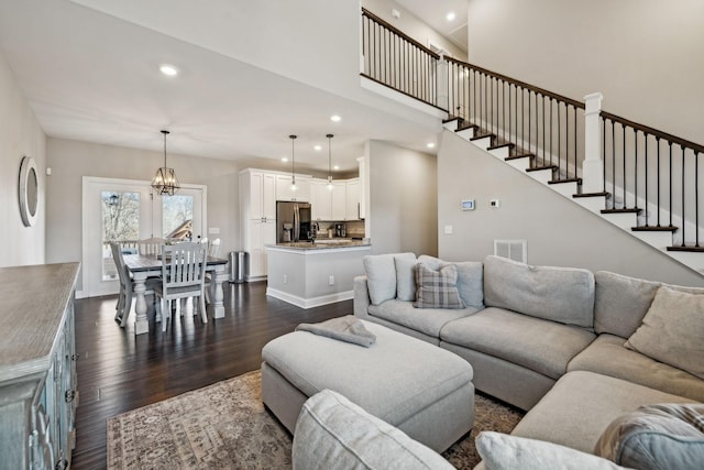 living room featuring dark wood-type flooring and a chandelier