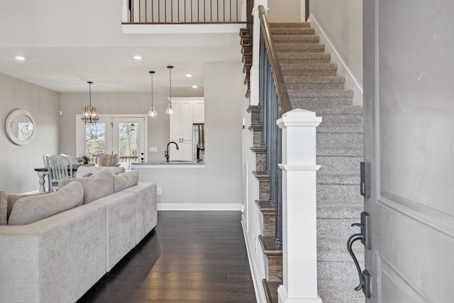 living room with dark hardwood / wood-style floors and sink