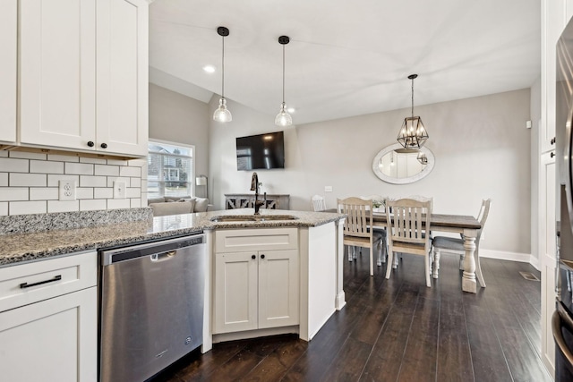 kitchen with pendant lighting, sink, stainless steel dishwasher, and white cabinets