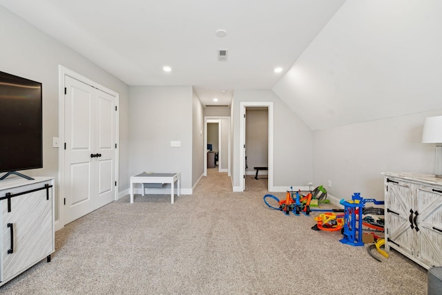 recreation room featuring light carpet and lofted ceiling