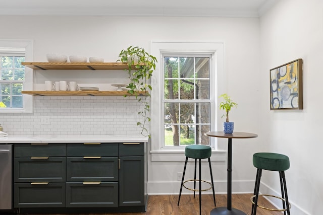 kitchen with backsplash, dark hardwood / wood-style floors, dishwasher, and plenty of natural light