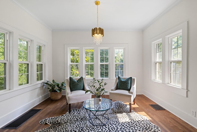 sunroom featuring a chandelier