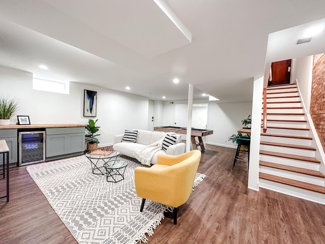 living room with bar, wine cooler, and dark wood-type flooring