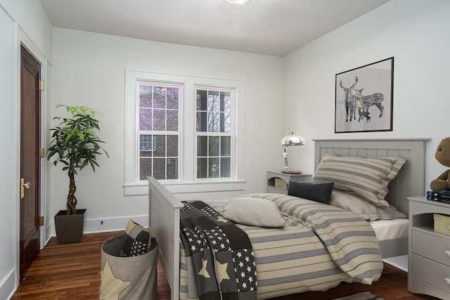 bedroom with dark hardwood / wood-style floors