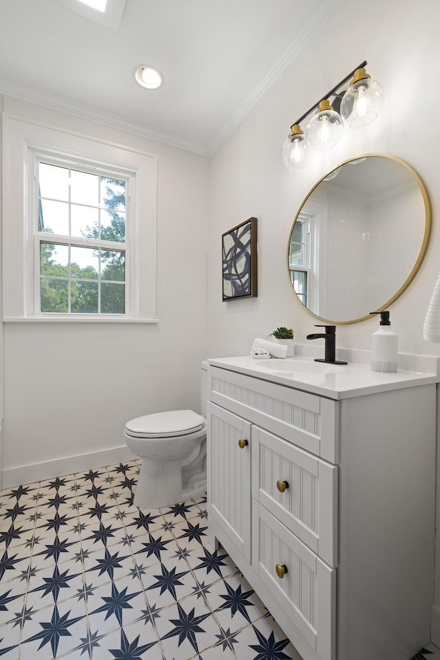 bathroom featuring toilet, vanity, and ornamental molding