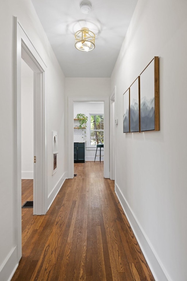 corridor with dark hardwood / wood-style floors