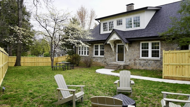 rear view of house with a lawn