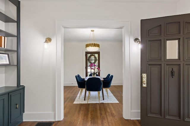 dining room featuring a chandelier and dark hardwood / wood-style flooring