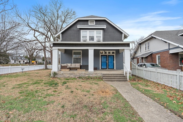 view of front facade featuring a front yard and a porch