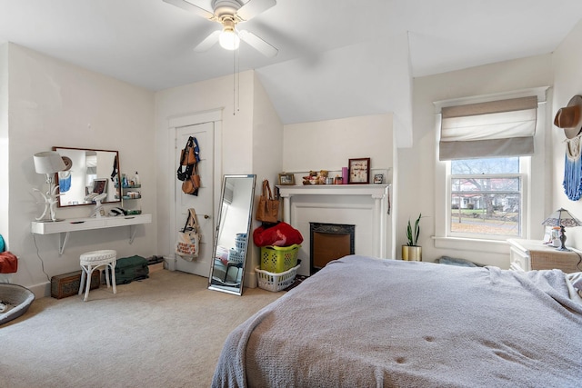 bedroom with ceiling fan, carpet, and vaulted ceiling