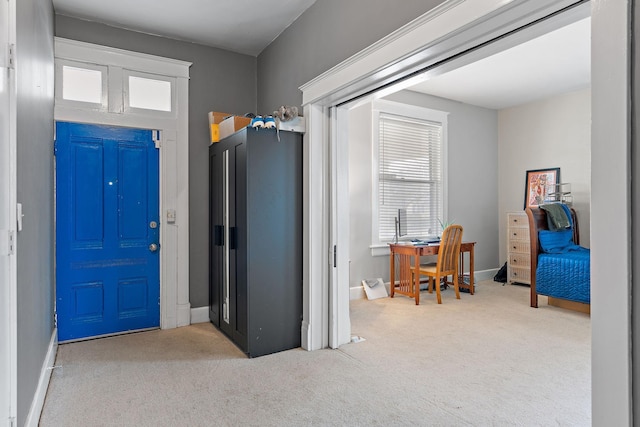 carpeted foyer entrance with plenty of natural light