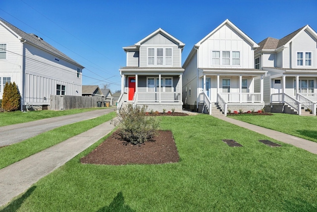 view of front of property with a porch and a front lawn