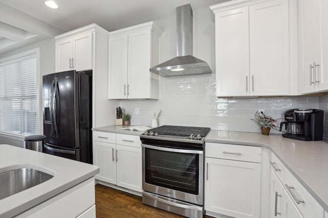 kitchen featuring wall chimney exhaust hood, white cabinetry, black fridge with ice dispenser, and stainless steel range with gas stovetop