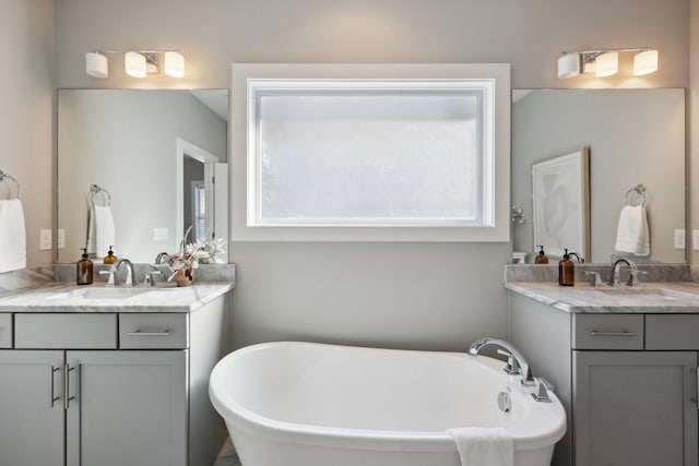 bathroom with a bath and vanity