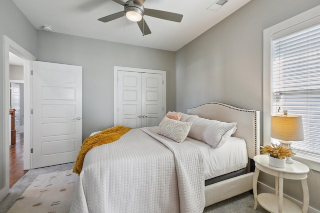 bedroom featuring a closet, ceiling fan, and light colored carpet