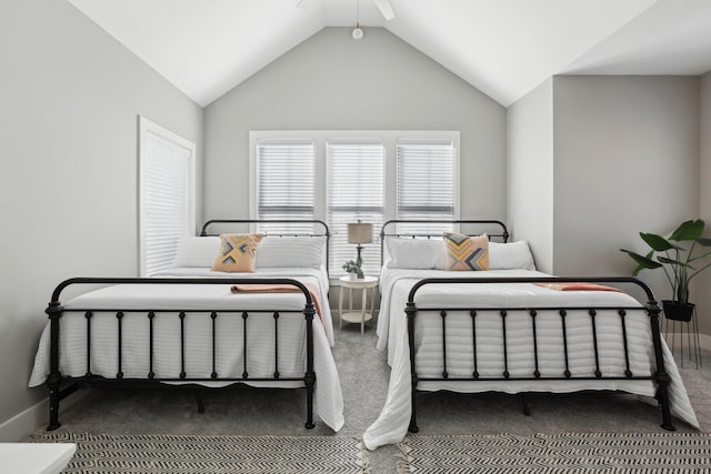 carpeted bedroom featuring vaulted ceiling and ceiling fan