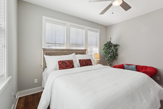 bedroom with ceiling fan and dark hardwood / wood-style flooring