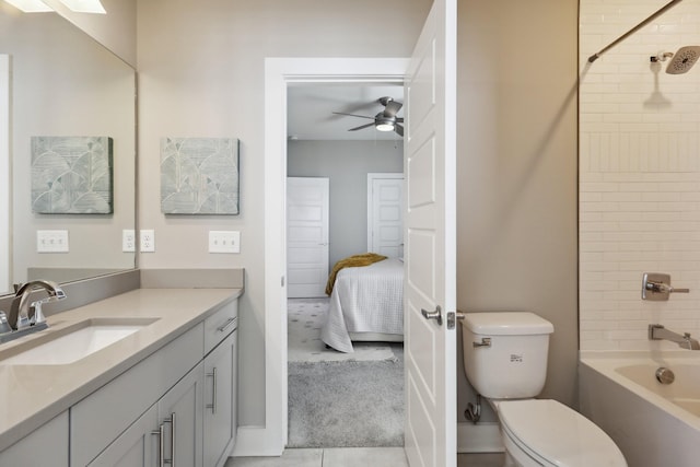 full bathroom featuring ceiling fan, toilet, vanity, and tiled shower / bath